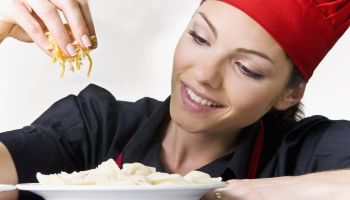 Female chef garnishing food