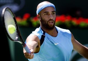 James Blake gets the ball right on the racket during a forehand shot against Roger Federer in the f