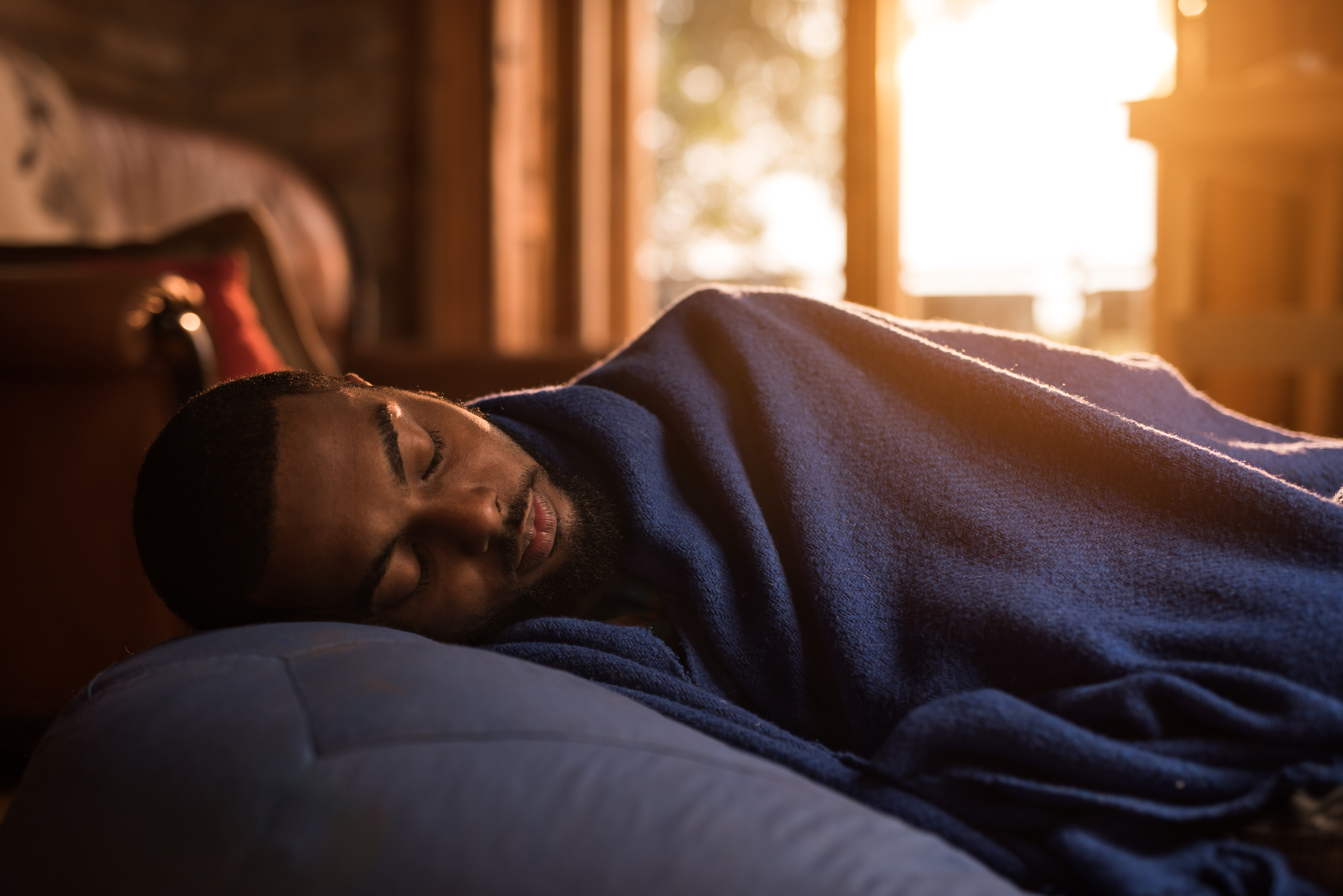 African American man taking a nap on a bean bag.