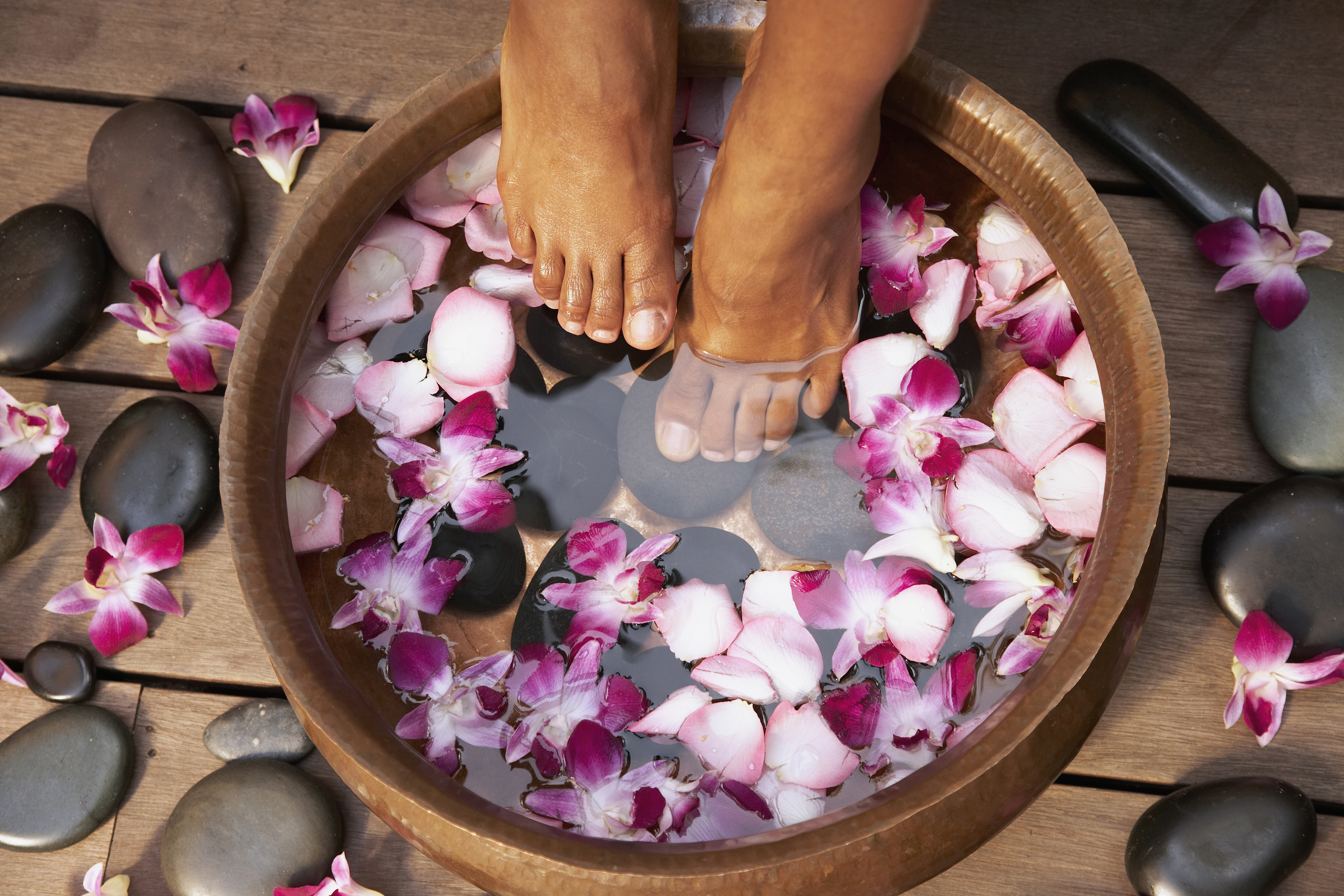 Close up of feet of Black woman soaking in bath