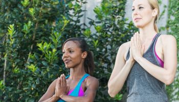 Two multi-ethnic women practicing yoga