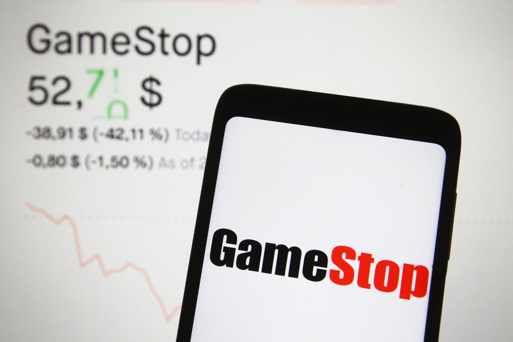 In this photo illustration a GameStop logo is seen on a...