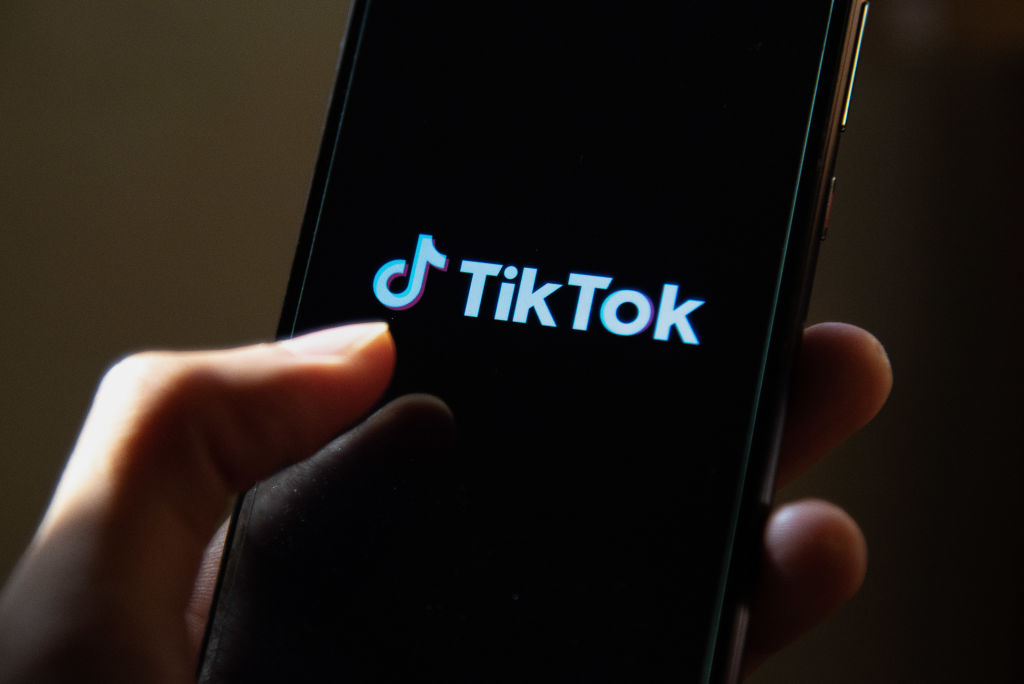 In this photo illustration, a TikTok App Logo seen displayed...