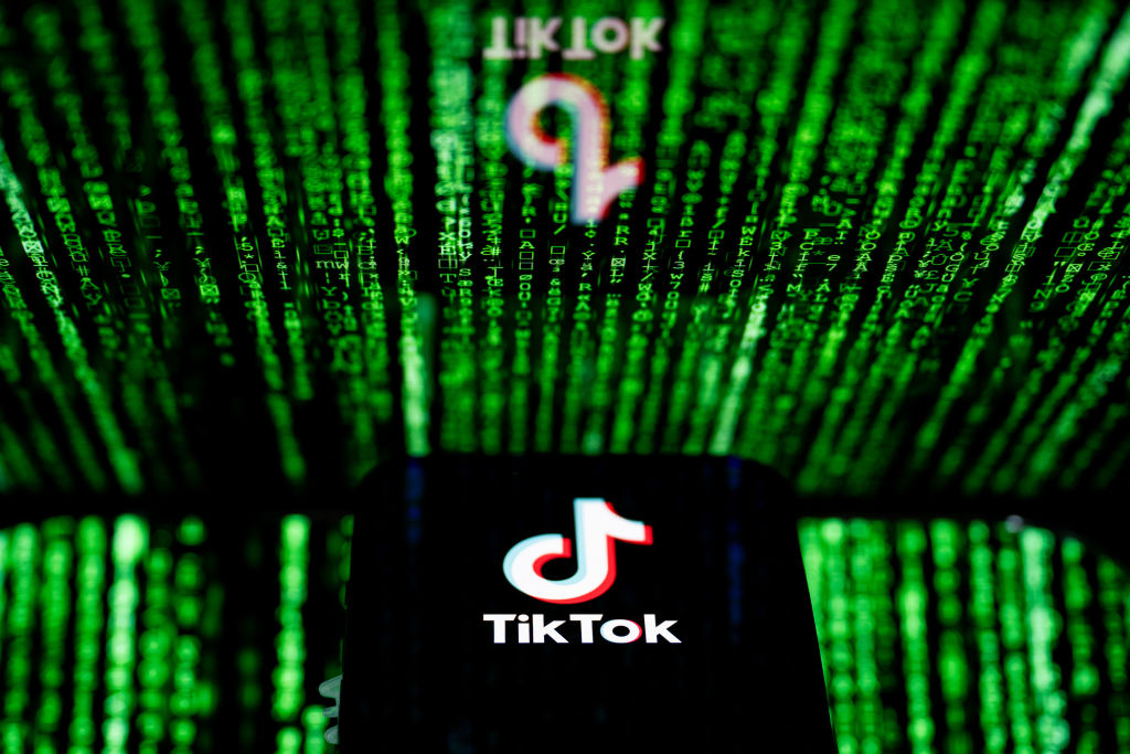In this photo illustration, the TikTok logo seen displayed...