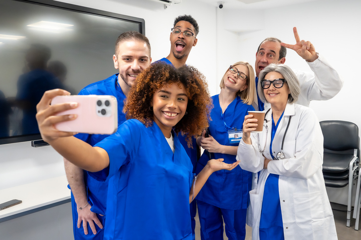 Diverse medical staff taking fun selfie together